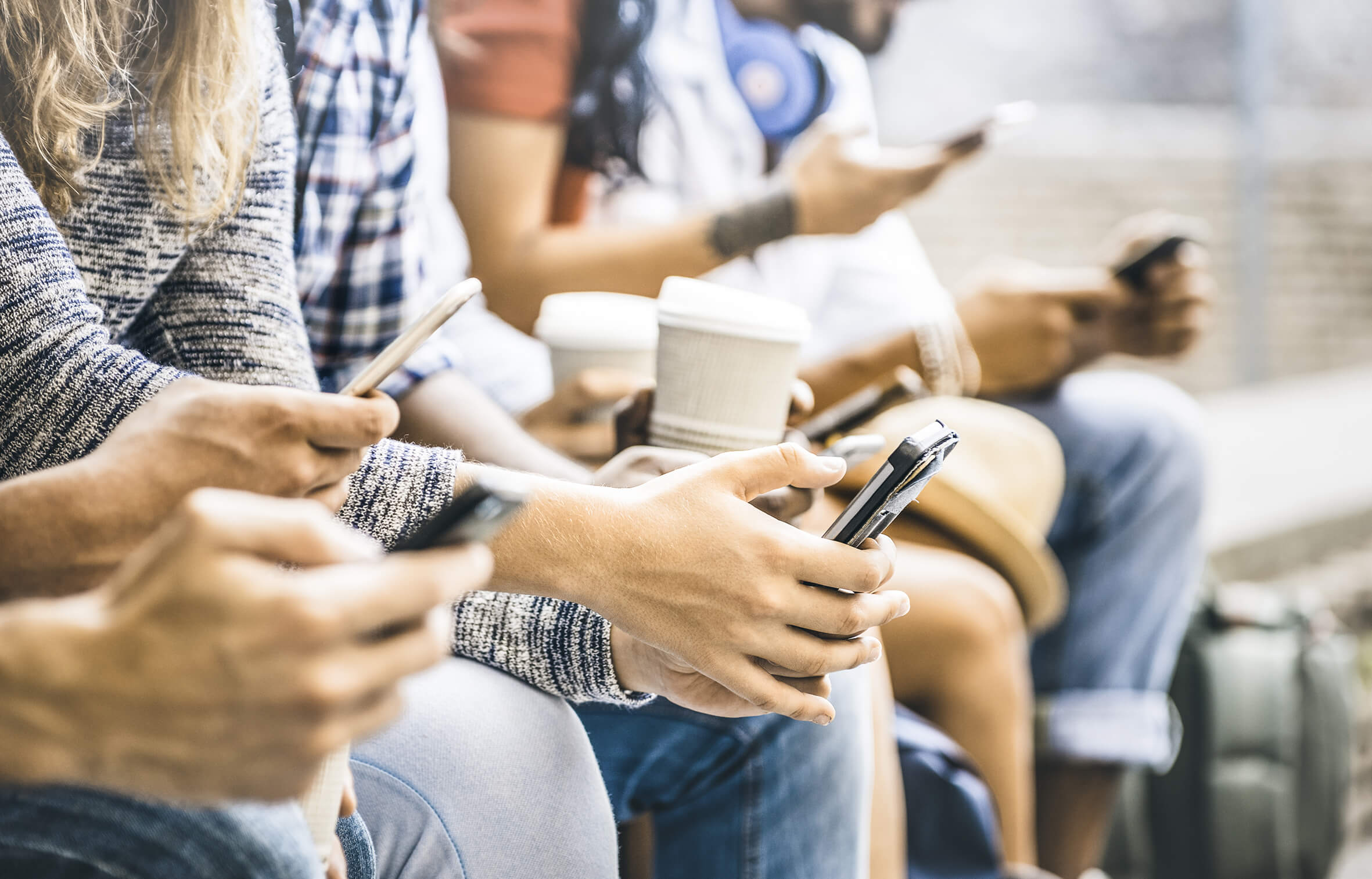 youths on mobiles with coffee