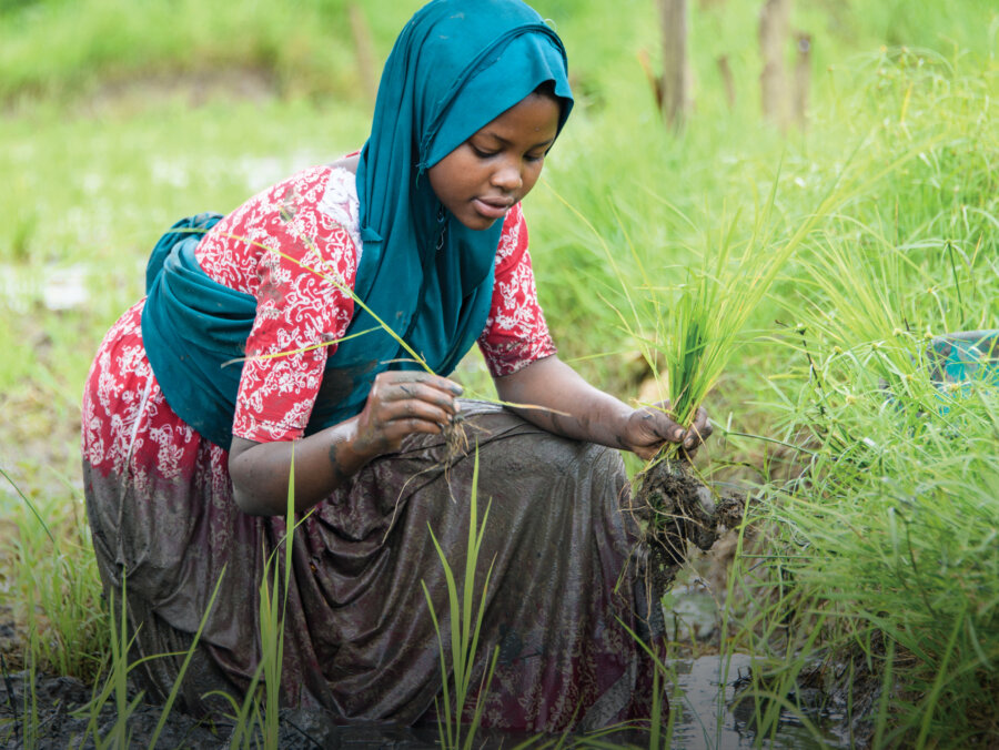 Unlimit Health image of a young girl working in a field